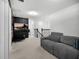 Upstairs living area features a comfortable gray sofa and a large flat screen TV at 17426 Saw Palmetto Ave, Clermont, FL 34714
