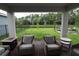 The covered patio has outdoor seating and views of the backyard at 17426 Saw Palmetto Ave, Clermont, FL 34714