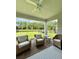Covered patio with fan and outdoor seating overlooking the backyard and wooded area at 17426 Saw Palmetto Ave, Clermont, FL 34714