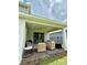 Covered patio with outdoor seating and a fire pit at 17426 Saw Palmetto Ave, Clermont, FL 34714