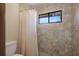 Bathroom shower with tile surround, window and shower curtain at 199 Heron Bay Cir, Lake Mary, FL 32746
