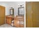 Bathroom featuring double sinks, granite countertop, and decorative mirrors at 199 Heron Bay Cir, Lake Mary, FL 32746