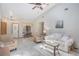 Bright and spacious living room with comfortable seating, skylight, and tile flooring at 199 Heron Bay Cir, Lake Mary, FL 32746
