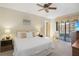 Calm main bedroom with plush carpet, a ceiling fan, and access to a private balcony at 199 Heron Bay Cir, Lake Mary, FL 32746