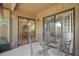 Patio with glass table and chairs looking into dining area and kitchen at 199 Heron Bay Cir, Lake Mary, FL 32746