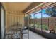 Patio with glass table and chairs with view of mulch garden bed at 199 Heron Bay Cir, Lake Mary, FL 32746