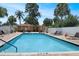 Outdoor community pool area with lounge chairs and palm trees at 199 Heron Bay Cir, Lake Mary, FL 32746