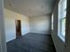 Bright bedroom with wood look floors, ensuite bath and modern lighting at 230 Lucile Way, Orlando, FL 32835