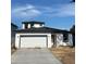 Charming two-story home with a two-car garage, sleek white exterior, and black trim at 230 Lucile Way, Orlando, FL 32835