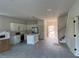 Open concept kitchen with island, stainless appliances and view into dining and living area at 230 Lucile Way, Orlando, FL 32835