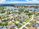 Aerial view of a neighborhood of single Gathering homes near a lake at 2375 Belen Dr, Deltona, FL 32738