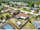 Aerial view of a home with a large backyard, shed, pool and a partially covered patio at 2375 Belen Dr, Deltona, FL 32738