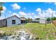 Large backyard showing the house, shed, fence, and lush greenery creating a private outdoor space at 2375 Belen Dr, Deltona, FL 32738