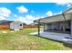 Spacious backyard with a covered patio, shed, and lush green lawn, perfect for outdoor activities at 2375 Belen Dr, Deltona, FL 32738