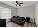 Bedroom features a window with blinds and black hardware with vinyl wood flooring at 2375 Belen Dr, Deltona, FL 32738