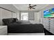 Bright bedroom featuring a ceiling fan, a large bed, and a TV for entertainment at 2375 Belen Dr, Deltona, FL 32738