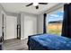Bedroom with view of the backyard and an oversized closet with vinyl wood flooring at 2375 Belen Dr, Deltona, FL 32738