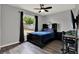Bedroom featuring a black book case headboard, work desk, and outdoor view from window at 2375 Belen Dr, Deltona, FL 32738