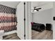 View from the bathroom looking to bedroom with a ceiling fan and black furnishings at 2375 Belen Dr, Deltona, FL 32738