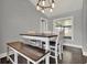 Bright dining room with a window, a modern light fixture, and a dining table with bench at 2375 Belen Dr, Deltona, FL 32738