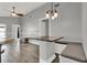 An open dining area with granite countertop, bar seating, and modern pendant lighting at 2375 Belen Dr, Deltona, FL 32738