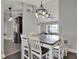 Open concept dining area features stylish chandelier and view into living and kitchen at 2375 Belen Dr, Deltona, FL 32738