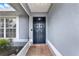 Welcoming front entryway featuring a solid black door and neutral-colored tile at 2375 Belen Dr, Deltona, FL 32738