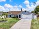 Charming single-story home featuring a well-manicured lawn and lush landscaping at 2375 Belen Dr, Deltona, FL 32738