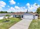 Charming single-story home featuring a well-manicured lawn and lush landscaping at 2375 Belen Dr, Deltona, FL 32738