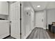 Well-lit hallway with wood-look flooring, leading to various rooms, including the laundry area at 2375 Belen Dr, Deltona, FL 32738