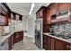 Beautiful kitchen with granite counters, stainless steel appliances, and dark wood cabinetry at 2375 Belen Dr, Deltona, FL 32738