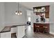 Open concept kitchen boasts a breakfast bar with seating and modern light fixtures, great for entertaining at 2375 Belen Dr, Deltona, FL 32738