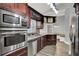 Spacious kitchen with stainless steel appliances, granite counters, and a connected dining area at 2375 Belen Dr, Deltona, FL 32738