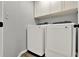 Well-lit laundry room featuring a modern washer and dryer set with bright white storage cabinets above at 2375 Belen Dr, Deltona, FL 32738