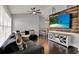 Open-concept living room featuring a large TV, a ceiling fan, and comfortable sofa at 2375 Belen Dr, Deltona, FL 32738