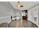 Bright, open living space with wood-look flooring, connecting the living area to kitchen at 2375 Belen Dr, Deltona, FL 32738