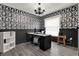 Home office featuring decorative wallpaper, overhead light fixture, and vinyl wood flooring at 2375 Belen Dr, Deltona, FL 32738