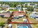 Aerial view of a home with a fenced yard, a shed, and a screened-in pool outlined in red at 2375 Belen Dr, Deltona, FL 32738