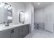 Bathroom featuring a double vanity with modern fixtures and a separate toilet area at 2444 Omaha Dr, Deltona, FL 32738