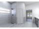 Well-lit bathroom featuring a sleek shower, large tiles and modern fixtures at 2444 Omaha Dr, Deltona, FL 32738