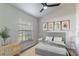 Bright bedroom features neutral tones, stylish furnishings, and a large window with natural light at 2444 Omaha Dr, Deltona, FL 32738