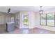 Cozy dining area with windows, a modern light fixture, and convenient access to the kitchen at 2444 Omaha Dr, Deltona, FL 32738