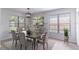 Elegant dining room with large windows, modern light fixture, neutral decor, and wood-look floors at 2444 Omaha Dr, Deltona, FL 32738