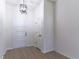 Inviting entryway featuring wood-look floors, neutral paint, modern lighting, and a convenient coat closet at 2444 Omaha Dr, Deltona, FL 32738