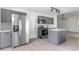 Updated kitchen featuring stainless steel appliances, gray cabinetry, modern lighting, and wood-look floors at 2444 Omaha Dr, Deltona, FL 32738