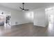 Open concept living room with modern ceiling fan, neutral paint, natural light, wood-look floors, and seamless flow at 2444 Omaha Dr, Deltona, FL 32738
