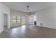 Bright living room featuring a modern ceiling fan, ample natural light, neutral paint, and wood-look floors at 2444 Omaha Dr, Deltona, FL 32738