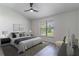 Serene main bedroom with modern ceiling fan, neutral decor, and a large window at 2444 Omaha Dr, Deltona, FL 32738