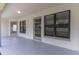 Covered patio with access doors and windows, providing a versatile outdoor living space at 2444 Omaha Dr, Deltona, FL 32738