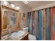 Colorful bathroom features a vanity with decorative tiles, unique light fixture and a shower at 25438 Pine Valley Dr, Sorrento, FL 32776